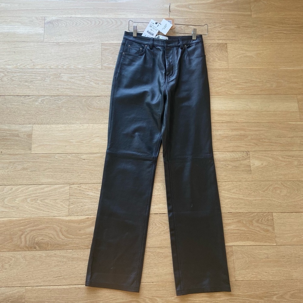 High waisted real leather pants with front and back pockets . Straight leg .
